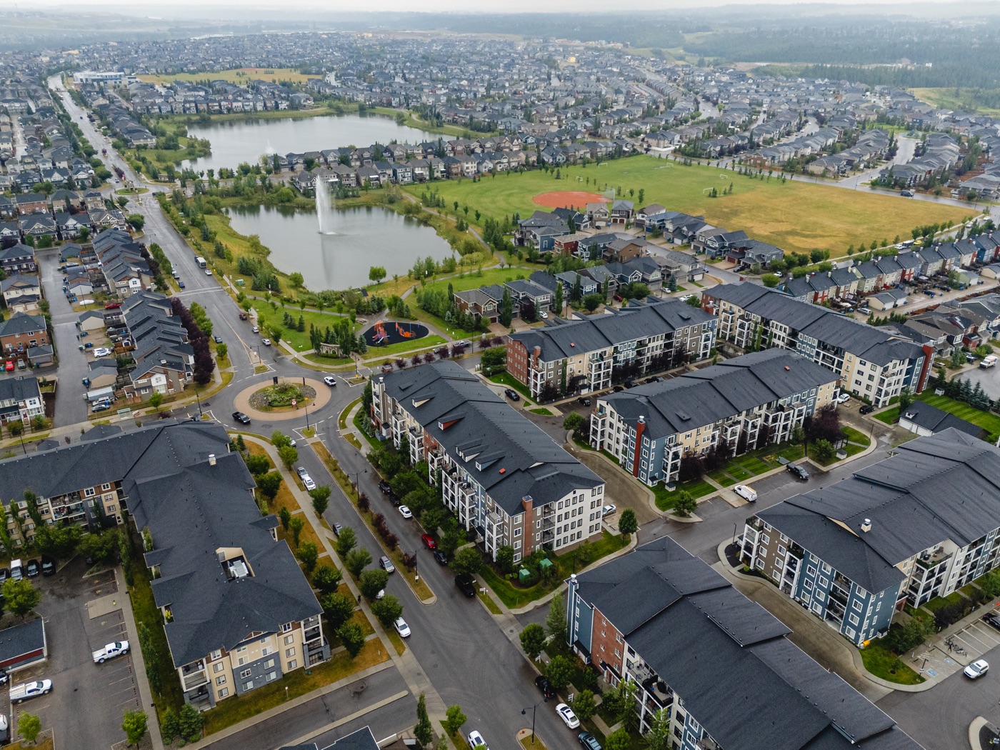 Aerial view of homes, ponds and green spaces in Legacy, Calgary